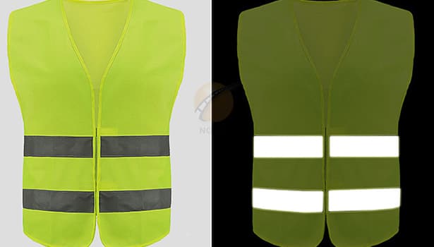 Fluorescent yellow reflective safety vest showing brightness in daylight and reflective strips glowing at night