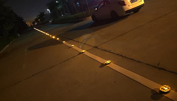 Embedded solar road studs illuminating highway at night for traffic safety