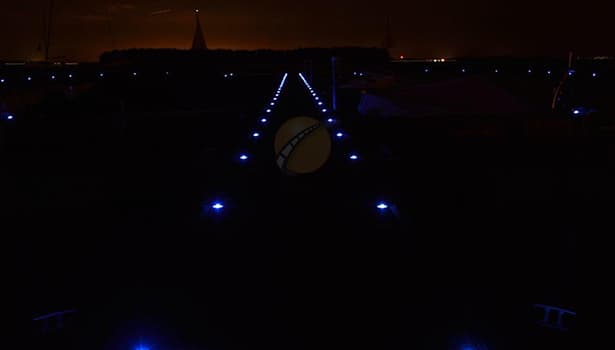 Blue solar road studs marking a special road in a developing country at night