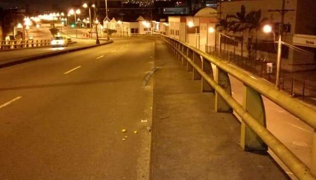 Urban road in a developing country illuminated by traditional street lights (comparison with solar road studs)