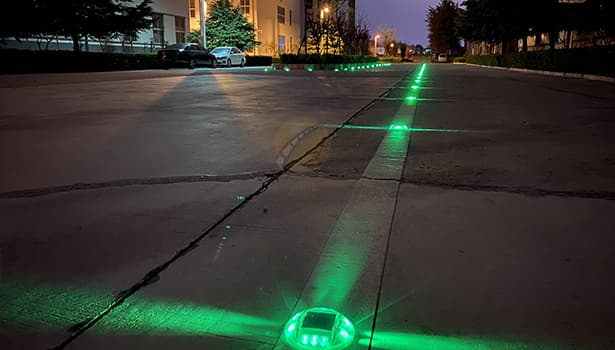 Green Solar Road Studs Lighting Up Road at Night