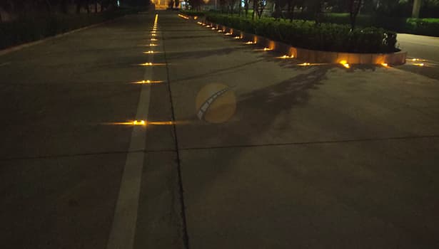 Yellow Solar Road Studs Illuminating Road at Night