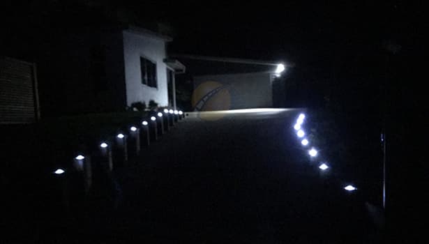 Solar cat's eyes road studs illuminating driveway at night