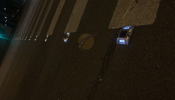 Solar cat eyes road studs installed on zebra crossing at night