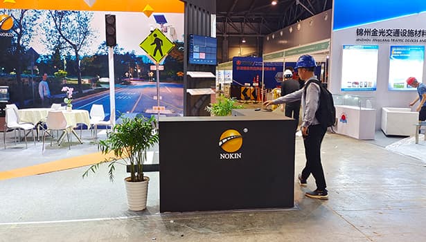 NOKIN solar road stud exhibition booth at traffic safety equipment trade show, showcasing road safety solutions