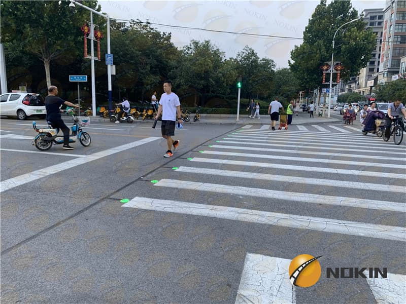 In roadway warning lights at crosswalks
